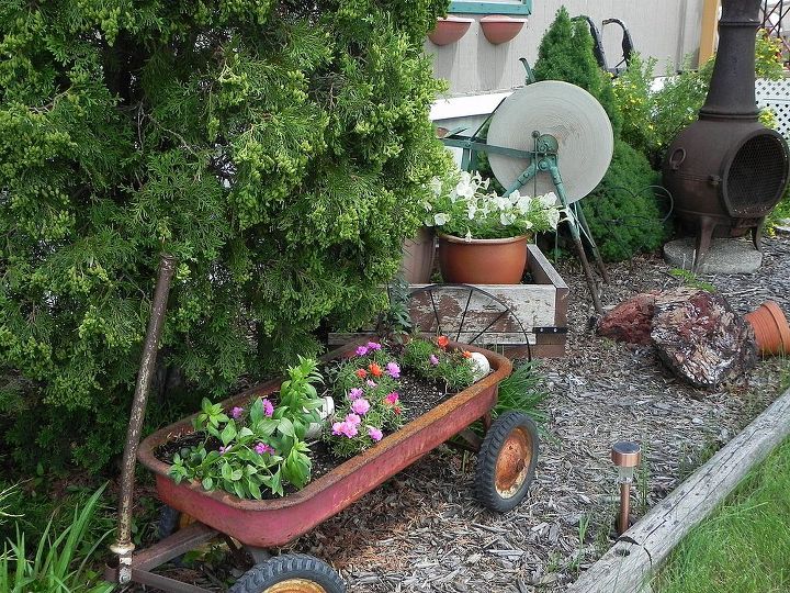 my gardentour, gardening, outdoor living, wagons and stone cutter are wonderful rustic accents