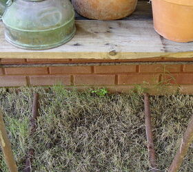 a stroll to my potting area with camera in hand, gardening, outdoor living, repurposing upcycling, My shelves to the left of the Pot House are made from leftover boards The table underneath is supported by the legs from the old green metal chair and the top is pallet wood