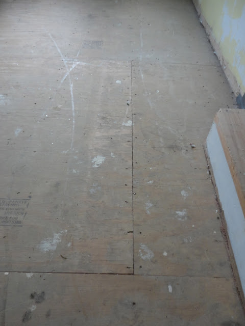 i painted my awful underlayment to look like hardwood floors i 3 it, Here is the before the ugly underlayment full of staples and paint I removed the staples used wood filler to fill gaps and then painted them
