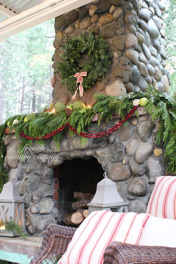 outdoor rock fireplace dressed for the holidays, christmas decorations, fireplaces mantels, seasonal holiday decor