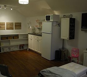 tiny attic apartment, home decor, organizing, urban living, wall decor, woodworking projects, The other side of the room has a small kitchen area The cabinets were purchased from the Habitat for Humanity ReStore and the refrigerator was free The book case separates the stairway from the room