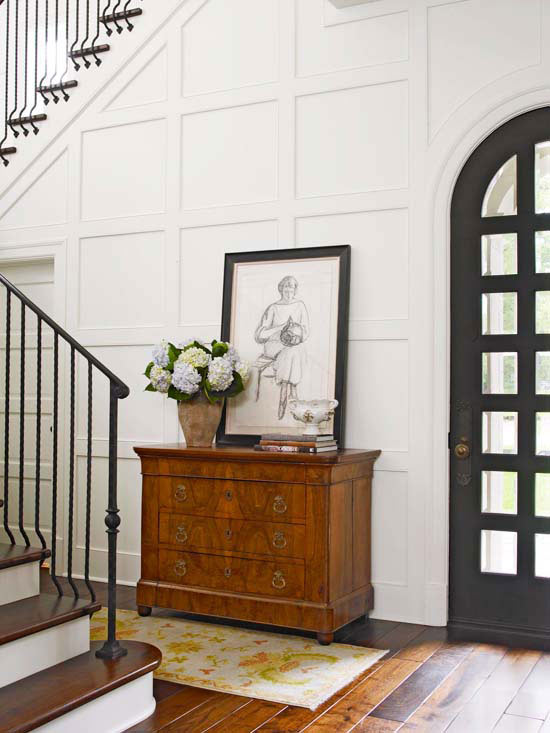 black trim is the simplest way to a stylish classic look, fireplaces mantels, home decor, Black trim on the front door the black frame and the staircase are enough to offset the white walls and wooden chest