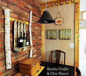 how we blended his rustic and her chic in our cabin decor, home decor, repurposing upcycling, I tried to re create the look of a favorite cafe with a brick wall and then I added some chic wall art with birch logs an old planter box and wine bottles The light fixture was made from an antique kitchen sifter