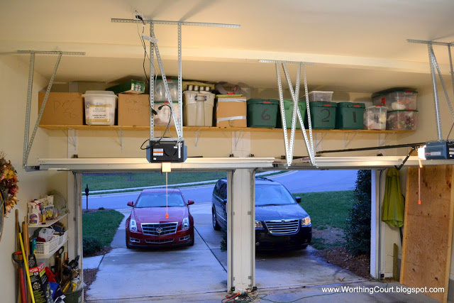 how to organize christmas decor, garage doors, garages, organizing, shelving ideas, An added shelf above the garage doors holds all of the boxes
