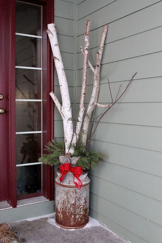 winter floral designs, gardening, porches, Birch branches and white pine tips make a lovely winter display in my old milk jug The bow was made with red burlap ribbon and adds great texture