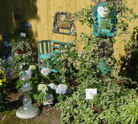 honored to host our first home garden tour this spring, flowers, gardening, outdoor living, Porcelain berry vine growing on a tree and some of my garden art We made the bench from thrift store chairs and my first glass totem is in foreground Thank you Empress of Dirt for the instructions