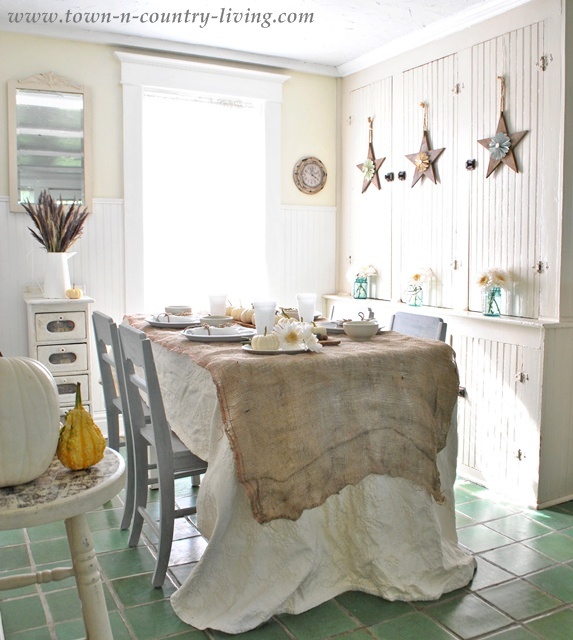 natural fall tablescape in the kitchen, kitchen design, seasonal holiday decor, For the table I layered a swatch of landscape burlap over a creamy mattelasse bedspread yes it s a bedspread