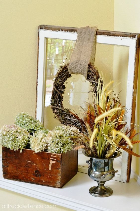 fall home tour, home decor, seasonal holiday decor, wreaths, An old window pane with a simple grapevine wreath provides the backdrop for this vignette on my staircase niche