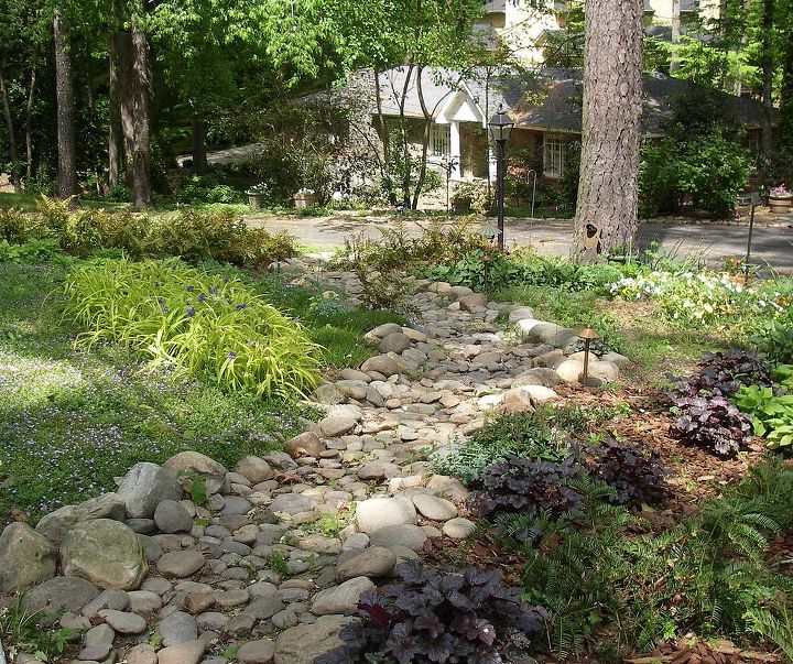 dry creek bed solves drainage problem from street front yard atlanta, landscape, perennial, ponds water features, We designed and installed this dry creek bed to channel storm runoff from street across the front yard of this Buckhead home in Atlanta to an existing ravine Note the use of handplaced river rock and colorful native perennials