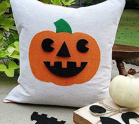 easy and cheap halloween ideas, crafts, halloween decorations, repurposing upcycling, seasonal holiday decor, My favorite a fun Jack o lantern pillow with interchangeable faces A pocket on the back stores the extras Find instructions here