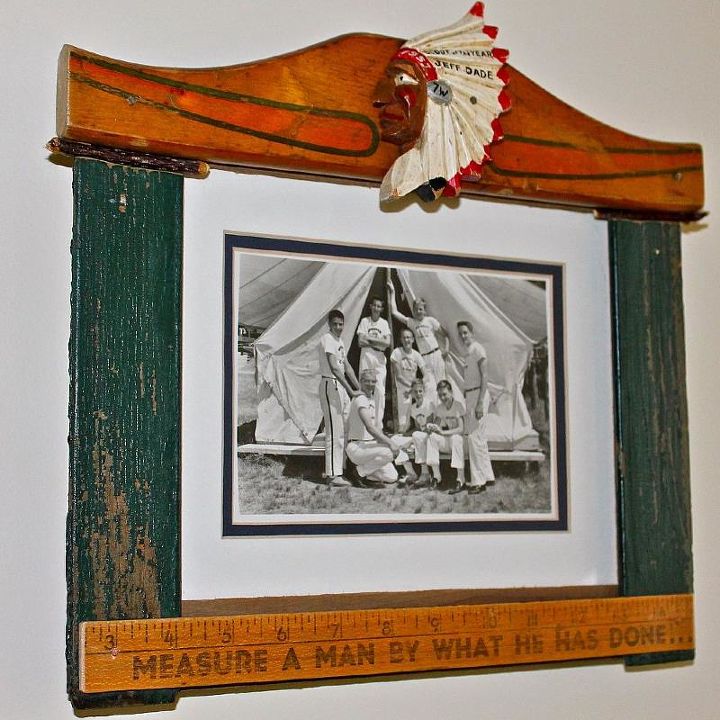 changing frames, crafts, repurposing upcycling, seasonal holiday decor, woodworking projects, Husband s old camp photo seemed like perfect place for his wooded Boy Scout neckerchief clasp Top red painted piece came from a sled