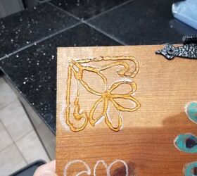 She spreads hot glue on an old cabinet door to get this one-of-a-kind accent