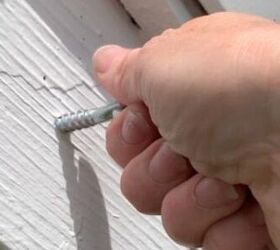 Why she screws eye hooks into the roof above her front door