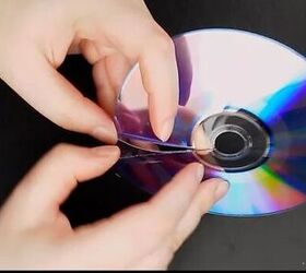 She peels apart her old CD's to get magical hanging decor