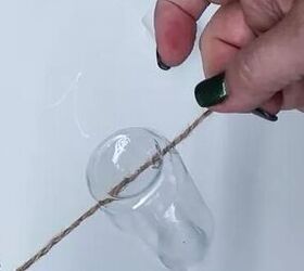 Poke twine through a plastic bottle to copy this almost magical wintertime decor idea