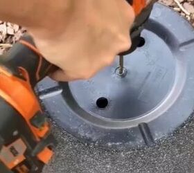 She drills into the bottom of 4 plastic flower pots for the smartest outdoor update