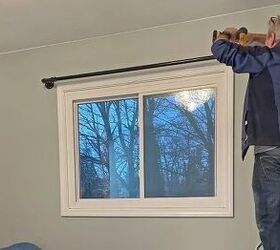 This couple hangs a pipe above their bedroom window—& it has nothing to do with curtains