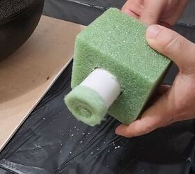 He pokes a PVC pipe through a green foam block to make his fall porch look incredible