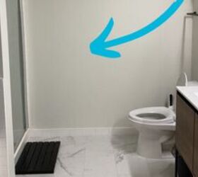 She hangs a single strip of wallpaper right next to her toilet for this stunning bathroom makeover