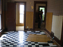 upstairs living room, hardwood floors, home improvement, Self stick black and white tiles over the most beautiful hardwoods I ve ever seen I ll never understand it It was a mess getting them up the sander did most of the work though and in the end the floors turned out good