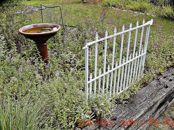 metal dog gate repurposed into decorative garden accent, fences, gardening, repurposing upcycling, Repurposed metal dog gate now a decorative garden accent in our raised herb bed