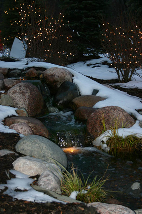 create a cozy winter water garden, gardening, lighting, outdoor living, ponds water features, A small waterfall looks inviting during the winter with the use of underwater lights