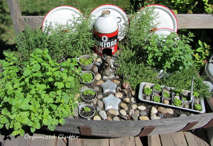 revisiting three whimsical junk garden vignettes, gardening, outdoor living, repurposing upcycling, The Kitchen Fairy Garden Jello molds measuring cups Rumford tin house with enamelware funnel roof lids