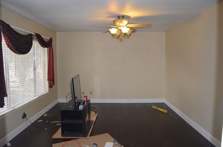 living room remodel base molding young hands and old walls, flooring, home improvement, living room ideas, wall decor, woodworking projects, The room is already looking great even with the molding only primed It really accents the floor