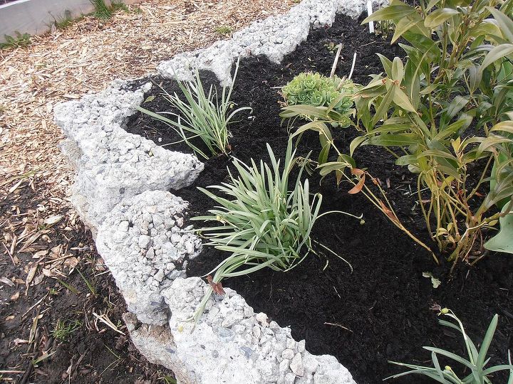 how to build a rock garden, gardening, landscape, succulents, The first layer of rock was dug down and placed at least halfway into the ground for stability Once the first layer was complete the next was layer was carefully placed on top in brick fashion Carefully select your rocks as you go