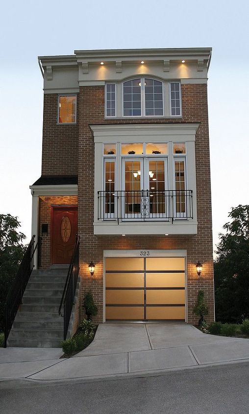 glass garage doors, This house shows that modern doors are right at home on a classic brownstone Clopay Avante Collection Bronze aluminum frame with frosted glass panels