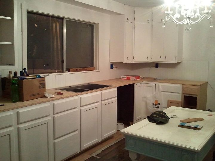 her home kitchen remodel, home decor, kitchen backsplash, kitchen design, kitchen island, New kitchen cabinets floors almost done sink dry fitted temporary plywood countertops