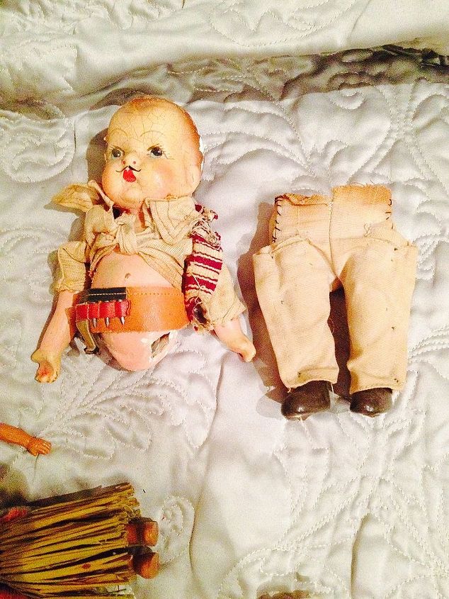 q how do you care for old dolls parts clothes, crafts, This little guy is just adorable He s got a tool belt on Someone tied his shirt up Any ideas