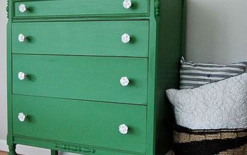 A Mossy Green Dresser With White Rose Knobs