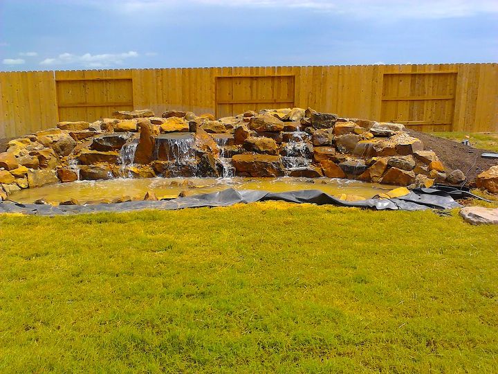 james wanted a twenty two foot wide waterfall in his sugarland texas backyard, landscape, outdoor living, ponds water features, Finally After days of moving and setting heavy rocks by hand we can finally turn it on and listen to the sound of the waterfalls as we finish up the rest of the details Very relaxing