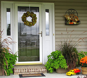 fun fall porch inspiration, outdoor living, repurposing upcycling, seasonal holiday decor, Purple Fountain Grass and Electric Lime Coleus flank the front door left over from the summer