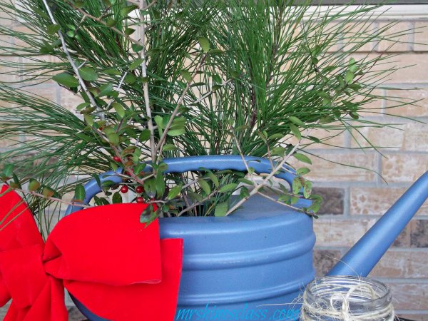 join me out on the front porch to see my outdoor christmas decor, outdoor living, porches, seasonal holiday decor, wreaths, fresh cut pine boughs and holly branches make this blue plastic watering can look like charming cottage Christmas decor