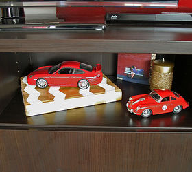 painting an ugly book with chalk and craft paint, chalk paint, crafts, painting, Here is the book hanging out in our entertainment stand complete with cars Don t you love how it glitzes up my husband s car collection