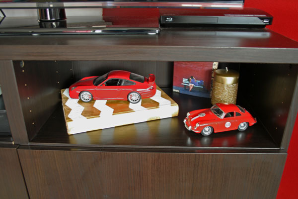 painting an ugly book with chalk and craft paint, chalk paint, crafts, painting, Here is the book hanging out in our entertainment stand complete with cars Don t you love how it glitzes up my husband s car collection