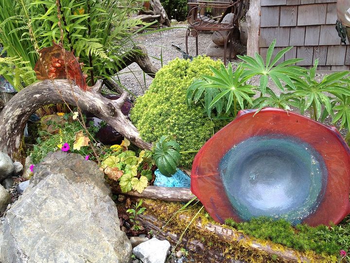 garden love lt 3, flowers, gardening, repurposing upcycling, succulents, Glass artisan Sol Maya displays his unusual pieces in his gardens outside his small A Frame shop He explained his passion for glass blowing like this Glass captures the light and light is in everyone of us Tofino BC
