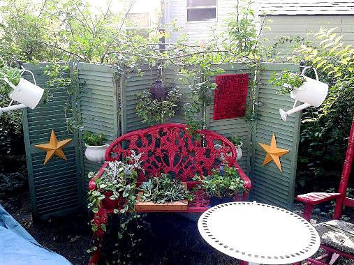 upcycling old shutters in the garden, outdoor living, repurposing upcycling, Cathy Cove used them as a brilliantbackground for her garden vignette
