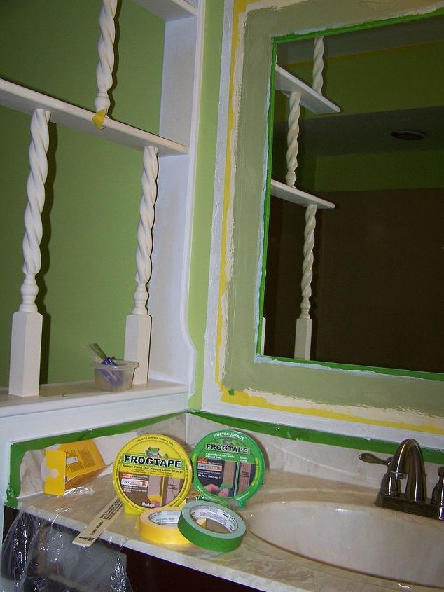 old bathroom mirror makeover decorative paint frame without mirror removal, bathroom, painting, I painted the inside of the frame in Sherwin Williams Artisan Leaf finish in a green color Notice that the outside part of frame was taped off first using FrogTape yellow for delicate surfaces after frame was completely dry