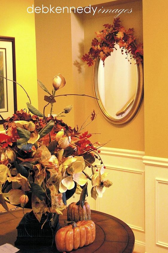 five easy steps to warm amp cozy fall decor, seasonal holiday decor, an entryway table and mirror get a seasonal update using bits of the same fall garland