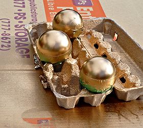easy gold dipped ornaments, christmas decorations, crafts, seasonal holiday decor, Spray paint the bottom of the ornaments egg cartons make great holders