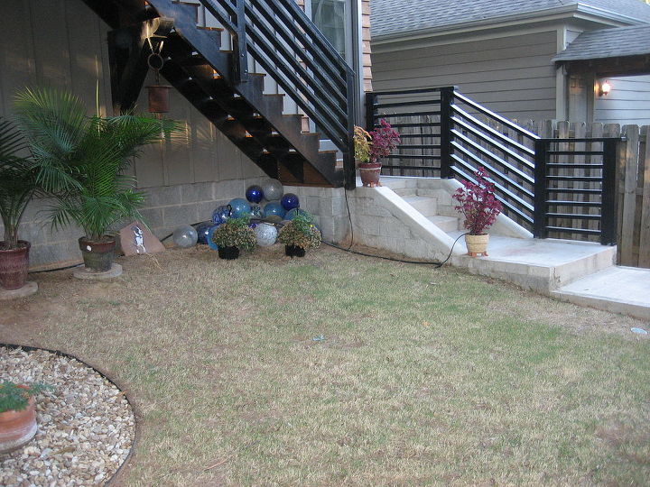 backyard koi pond, This is an angled view of the area for the pond Under the stairs that go to an apartment above the garage I intend to run a row of cinderblocks that will parallel the garage wall I will then fill this area with dirt from the dig and plant shade loving specimens in this area the pond would begin in front of this planting area