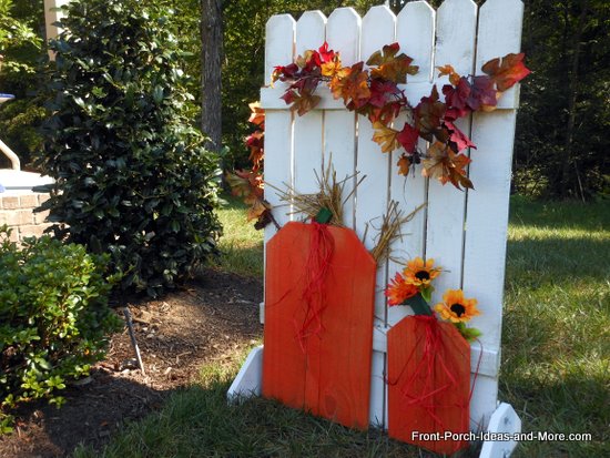 make an easy autumn pumpkin fence, fences, outdoor living, seasonal holiday decor, Cute folk art pumpkins adorn the fence