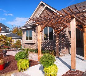 custom cedar arbor enhances home s front entrance and paver patio provides sitting, A beautiful space is created at the homes entrance The space is a transition zone that leads to the front yard patio or front door