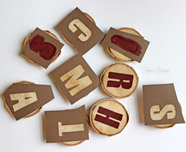 merry christmas wood slice garland, christmas decorations, crafts, seasonal holiday decor, I cut letters using my Silhouette and tacked them onto the woodslices then using a foam brush in a pouncing motion stenciled the letters on