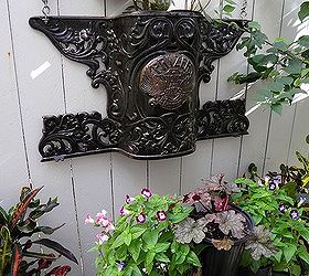 garden whimsey, gardening, Antique stove part used as planter on fence I love this piece I change the plants with the season