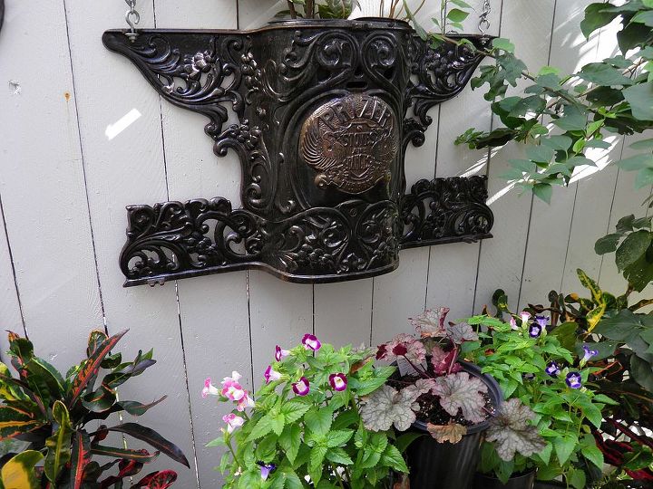 garden whimsey, gardening, Antique stove part used as planter on fence I love this piece I change the plants with the season