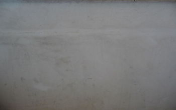 I posted a question a few weeks ago about painting concrete walls with dents and peeling paint.